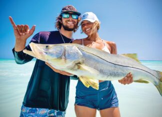 Off the Charts: Reel Paradise Adam and Anika Mellusi show off a giant Jupiter beach–caught snook. Photo by George LaBonte