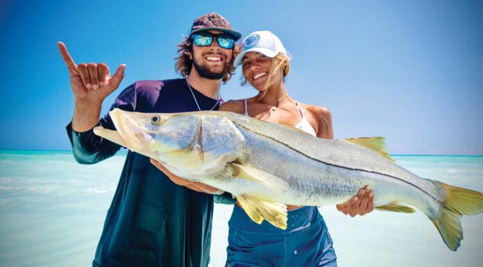 Off the Charts: Reel Paradise Adam and Anika Mellusi show off a giant Jupiter beach–caught snook. Photo by George LaBonte