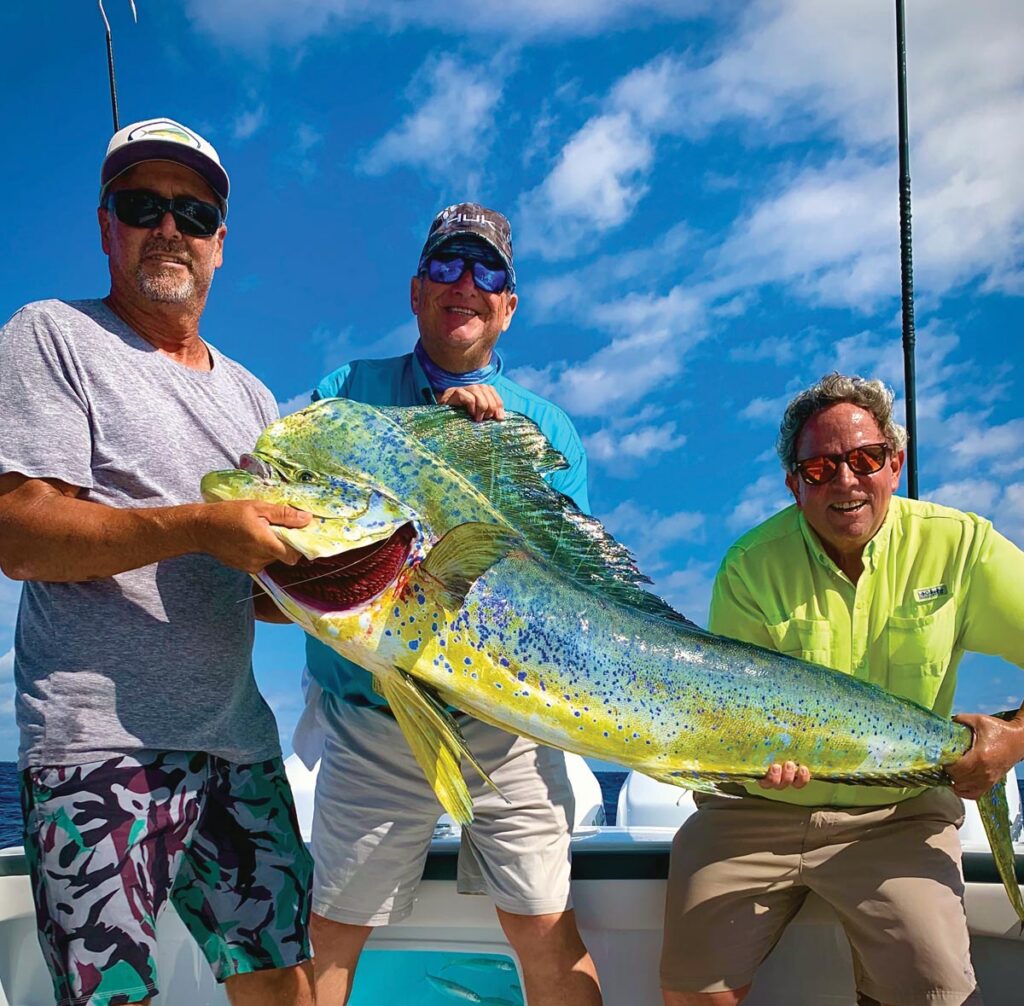 Mike Searle with a lifetime best 62-pound mahi caught on live bait off the coast of Jupiter. Photo courtesy of George LaBonte